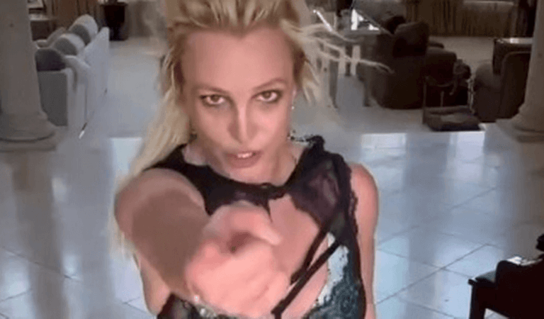 With her figure flaunted in lace bralette and red thong, Britney Spears performs a sultry dance routine