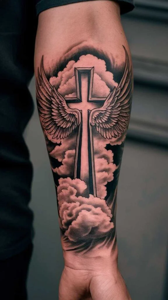 This image has an empty alt attribute; its file name is Cross-With-Wings-and-Clouds-forearm-tattoo-576x1024.jpeg